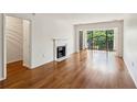 Hardwood floors, fireplace, and balcony with view in a naturally lit living room at 23310 Plantation Ne Dr, Atlanta, GA 30324