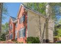 Side view of a brick and siding home with a chimney and a well-manicured lawn at 2566 Garrison Sw, Marietta, GA 30064