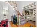 Welcoming home foyer featuring hardwood floors, a staircase, and adjacent living area at 4415 Dorset Ln, Suwanee, GA 30024