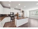 Modern kitchen featuring stainless steel appliances, granite countertops, and an island with seating at 787 Belrose Dr, Smyrna, GA 30080