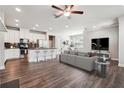 Open-concept living room and kitchen with stainless steel appliances and island seating at 787 Belrose Dr, Smyrna, GA 30080