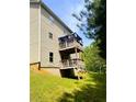 Two-story wooden deck overlooking a grassy backyard with wooded area beyond at 4346 Traipse Path, Ellenwood, GA 30294