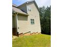 Side view of a light-colored house with vinyl siding and green grass at 4346 Traipse Path, Ellenwood, GA 30294