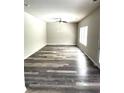 Bright living room with ample natural light and modern gray wood-look flooring at 4346 Traipse Path, Ellenwood, GA 30294