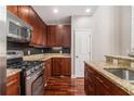 Well-equipped kitchen with stainless steel appliances, granite countertops, and ample cabinet space at 6023 Brookside Oak Cir, Norcross, GA 30093