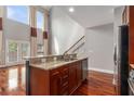 Kitchen island with granite countertop and sink overlooking the living area and outdoor access at 6023 Brookside Oak Cir, Norcross, GA 30093