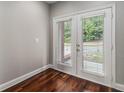 Bright room with hardwood floors featuring white framed patio doors and outside view at 6023 Brookside Oak Cir, Norcross, GA 30093