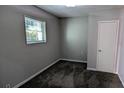 This bedroom features a neutral color palette, carpet, window and closet at 103 Rigby Ne St, Marietta, GA 30060