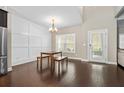 Bright dining area with modern light fixture, chair rail detail, and hardwood floors at 1536 Drew Nw Dr, Atlanta, GA 30318