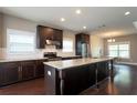 Spacious kitchen with granite countertops, dark cabinetry, stainless steel appliances, and hardwood floors at 1536 Drew Nw Dr, Atlanta, GA 30318