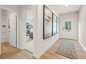 Inviting entryway with wood floors, stylish rug, and elegant artwork leading into the home at 8507 Polston Place Lot 140, Douglasville, GA 30134