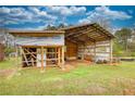 Exterior shot of a barn with exposed framing and a partially covered area at 1277 Bethany Rd, Covington, GA 30016
