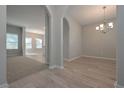 Open-concept living room with a view of the dining area showcasing archways and elegant lighting fixtures at 16 Deer Place, Villa Rica, GA 30180