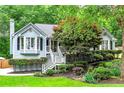 Inviting home with a white picket fence and lush, colorful landscaping at 489 Warrenton Dr, Douglasville, GA 30134