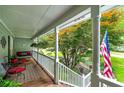 Covered front porch with swing, ample seating, and a lovely garden view at 489 Warrenton Dr, Douglasville, GA 30134