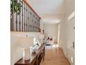 Welcoming entryway with hardwood floors, staircase, console table, and views into the living area at 1038 Huntcliff, Atlanta, GA 30350