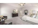 Spacious main bedroom with a ceiling fan, neutral decor, and a walk-in closet for all your storage needs at 2706 Sw Riverpine Lot 176 Sw Trl, Atlanta, GA 30331