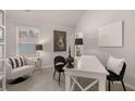Bright, modern office featuring neutral decor, a stylish desk, and a large window offering natural light at 2706 Sw Riverpine Lot 176 Sw Trl, Atlanta, GA 30331