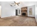 Open living room featuring a stone fireplace and ample natural light, creating a cozy atmosphere at 285 Independence Dr, Jonesboro, GA 30238