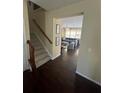 View of entry hall with hardwood floors, staircase, and an open living space with lots of natural light at 985 Forest Knoll Court, Lithia Springs, GA 30122