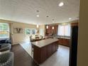 Spacious eat-in kitchen featuring stainless appliances, tile floors, central island and sliding doors to the deck at 985 Forest Knoll Court, Lithia Springs, GA 30122