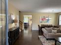 Inviting living room and dining area feature hardwood floors and lots of natural light at 985 Forest Knoll Court, Lithia Springs, GA 30122