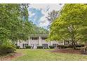 Traditional home with a white brick facade, symmetrical windows, and well-manicured landscaping at 2985 Duke Of Gloucester, Atlanta, GA 30344