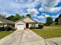 Charming home with manicured lawn, driveway, and a one-car garage under a blue sky at 320 Little Creek Rd, Lawrenceville, GA 30045