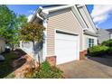 Exterior view of the garage, showcasing brick accents and tidy landscaping near the home at 320 Little Creek Rd, Lawrenceville, GA 30045