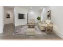 Comfortable living room with neutral decor, plush seating, a stylish rug, and hardwood floors at 5920 Bond St # B206, Cumming, GA 30040