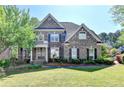 Charming two-story brick home featuring well-maintained landscaping and a welcoming front entrance at 1806 Royal Troon Ct, Duluth, GA 30097