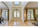 Elegant foyer with high ceilings, hardwood floors, and decorative glass front doors at 1806 Royal Troon Ct, Duluth, GA 30097