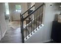 Carpeted staircase with dark metal railings, leading to the upper level of the home at 586 Rodeo Dr, Auburn, GA 30102