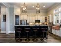 Modern kitchen with stainless steel appliances, granite counters, and stylish barstool seating at 1762 Patrick Rd, Dacula, GA 30019