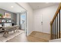 Inviting entryway with a view of a light-filled home office featuring stylish decor and a comfortable workspace at 8511 Polston Place- Lot 138, Douglasville, GA 30134