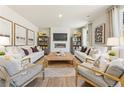 Bright living room featuring a modern fireplace, stylish decor, and comfortable seating, perfect for relaxing and entertaining at 8511 Polston Place- Lot 138, Douglasville, GA 30134