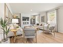 Open living room with modern fireplace, bright windows, and a contemporary design at 8511 Polston Place- Lot 138, Douglasville, GA 30134