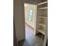 Hallway with exposed shelving and a view of a bedroom with a window, showing the house's layout at 1099 Warren Dr, Riverdale, GA 30296