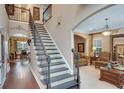 Spacious entryway showcasing a staircase with rod iron railing and hardwood floors flowing into the living spaces at 1705 Butler Bridge Rd, Covington, GA 30016