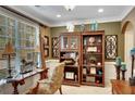 Bright office with a large window, custom bookshelves, and elegant decor creating a comfortable workspace at 1705 Butler Bridge Rd, Covington, GA 30016