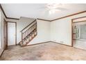 A blank living room with carpet, a staircase, and neutral walls at 495 Buttercup Trl, Lawrenceville, GA 30046