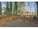 A newly built wooden deck overlooks a grassy backyard with mature trees at 4210 Pepperdine Dr, Decatur, GA 30034