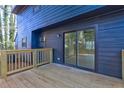 View of the house's deck with wooden flooring and railings at 4210 Pepperdine Dr, Decatur, GA 30034