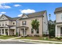 Two-story brick home featuring manicured landscaping and a covered front porch, exuding curb appeal at 1179 Bennett Creek Overlook, Suwanee, GA 30024