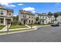 Street view of beautiful two-story homes with manicured lawns, sidewalks, and lush landscaping at 1179 Bennett Creek Overlook, Suwanee, GA 30024