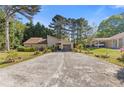 Inviting home with lush landscaping, attached garage, and lengthy driveway at 2520 Hartford Dr, Ellenwood, GA 30294