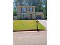 Charming two-story home with manicured lawn and attached garage at 2044 Mallard Crest, Lithonia, GA 30058