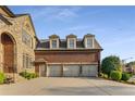 Three-car garage with a brick exterior and private entrance at 895 Ovalene Sw Ln, Marietta, GA 30064