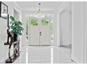 Bright foyer with elegant lighting, contemporary decor, and white tile flooring at 1081 Humphries Nw Rd, Conyers, GA 30012