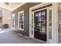View of the front porch with a stained wood door, sidelights, and stone accents at 617 Wexford Ct, Acworth, GA 30102